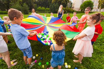 Wall Mural - Cheerful children playing outdoors at birthday party