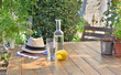 © coco - close on water drink and apple on a wooden table in garden  of a country house