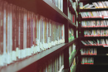 Compact Discs Arranged On Shelf In Library