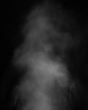 White Clouds Of Smoke Vapor Isolated On A Black Background. The Magic Effect Of Foggy Dust, Which Can Be Used When Applying And Changing Their Transparency
