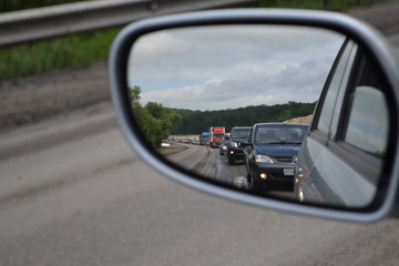 Reflection of traffic jam in the mirror