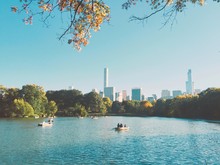 Boats In Lake Against Buildings And Sky At Central Park On Sunny Day