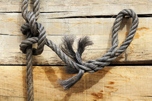 Close-up Of Sailor Knot On Wooden Plank