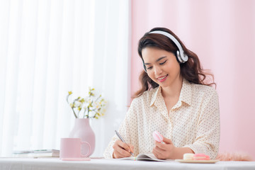 Fototapete - Happy excited young woman in glasses listening to music in office and having an idea
