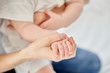 © Aleksandr - Close-up, baby's hand in mom's hand.