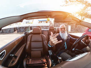 Hipster stylish man inside convertible car - Senior entrepreneur having fun with cabriolet auto - Fashion, elegant and business concept - Focus on face