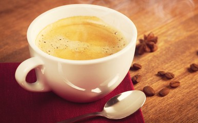 Poster - A cup of fresh coffee and coffee beans on the desk