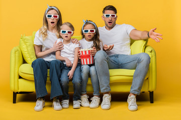 Wall Mural - shocked family in 3d glasses watching movie on sofa with popcorn bucket on yellow