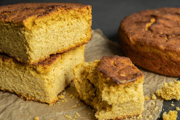 Freshly baked sliced and unsliced corn bread on baking paper. Delicious, organic and healthy homemade food.