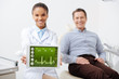 © LIGHTFIELD STUDIOS - selective focus of cheerful african american dentist holding digital tablet with heartbeat rate on screen near happy patient