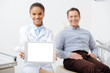 © LIGHTFIELD STUDIOS - selective focus of smiling african american dentist holding digital tablet with white screen near happy patient
