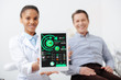 © LIGHTFIELD STUDIOS - selective focus of cheerful african american dentist holding digital tablet with charts and graphs on screen near happy patient