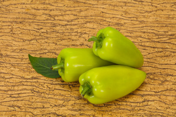 Green bell pepper over wooden background