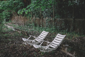 Two wooden chairs in the garden on the nature.