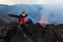 Democratic Republic Of Congo - March 10, 2018. Tourist Excited By Lava Lake On Top Of Nyiragongo Volcano