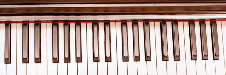 modern piano synthesizer keypad of black and white colours stands on illuminated stage