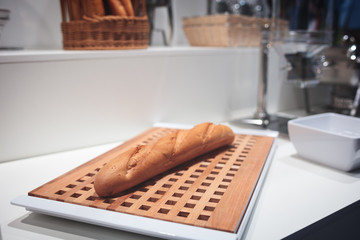 Poster - Hotel service concept.  Fresh bread on wooden table.