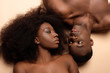 overhead view of sexy naked african american couple lying on beige