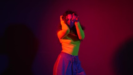 Wall Mural - African-American woman dancing against dark background