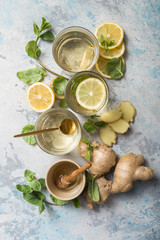 Wall Mural - Lemon and ginger tea with honey. Healthy ingredients against cold. Top view image  with copy space. get rid of toxins and boost.