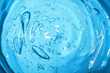 Hyaluronic acid cosmetic gel. Gel texture with bubbles on a blue background. Transparent smear of gel