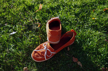 Close-up Of Red Moccasins On Grass