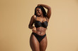 © Indico Studio/ADDICTIVE STOCK - Curvy beautiful African American woman with braids in lingerie with closed eyes against yellow background