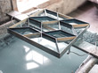© PHILIPPE DEGROOTE/ADDICTIVE STOCK - From above of metal tile ornamental stencil on board above container of water with blue glaze after washing