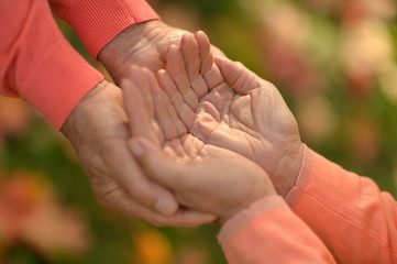 Portrait of couple holding hands together close up 