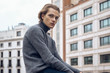 © Cien X Cien Studio/ADDICTIVE STOCK - Modern serious young male with stylish haircut in gray warm sweater