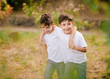 © Gabriel Trujillo/ADDICTIVE STOCK - Happy twin boys hugging and looking away in park