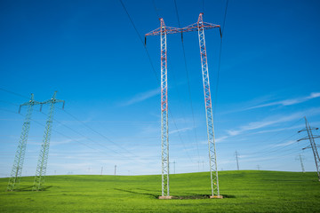 Electric pole in the center of the beautiful green fields