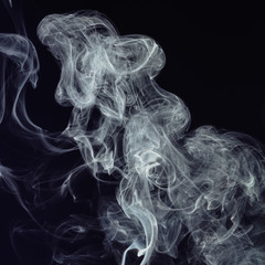 Beautiful white smoke on black background. Movement of abstract smoke on dark background