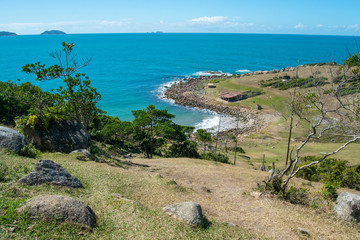 Wall Mural - Maço beach, in Palhoça. Beautiful beach among green mountains and rocks in Santa Catarina, Brazil