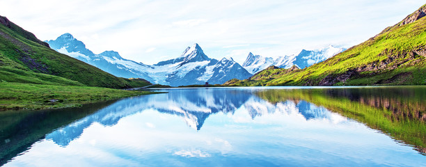 Fantastic landscape with the lake in the Swiss Alps. Wetterhorn, Schreckhorn, Finsteraarhorn et Bachsee. exotic places. magical scenes. panorama