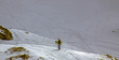 Skier walking uphill on snow mountain