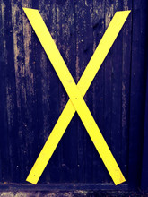 Large Yellow Cross Sign On Wall