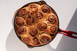 Baked cinnamon rolls in a cast iron pan