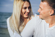 © Daria - Lifestyle romantic evening for two. Young lovers went on a trip to the sea. Sitting on the sand in the evening sun and hugging, talking, kissing and enjoying the absence of people around.