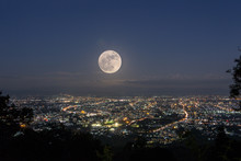 Majestic Full Moon Over Illuminated City Against Sky