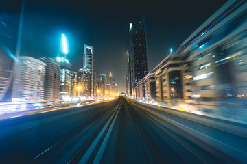 metro track with skyline at night Dubai - UAE