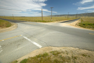 A four way intersection of four roads in the desert near Lancaster, CA