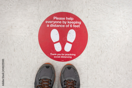 Social distancing at Target Store with a foot print marker every six feet in the checkout line during the Covid-19 pandemic. St Paul Minnesota MN USA