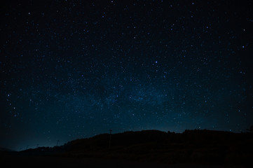 Wall Mural - starry sky on a background of a slope, night landscape. astrology, horoscopes, astro screensaver, sp