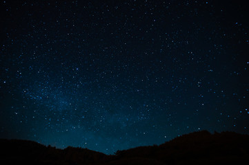 Wall Mural - starry sky on a background of a slope, night landscape. astrology, horoscopes, astro screensaver, sp