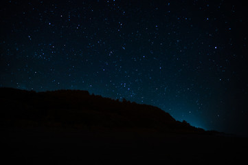 Wall Mural - night landscape with starry sky. astrology, space
