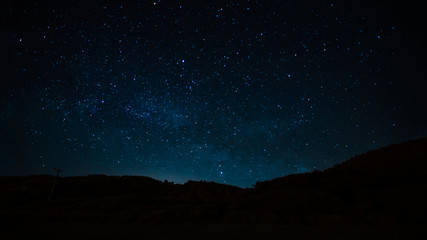 Wall Mural - night landscape with starry sky. astrology, space