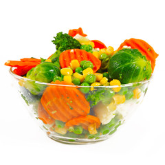 Wall Mural - Frozen vegetables in a glass bowl on a white background