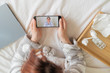 © Михаил Решетников - Unrecognizable woman with a cold talking to a doctor through video chat on a smartphone. friendly doctor gives an online consultation to the patient.