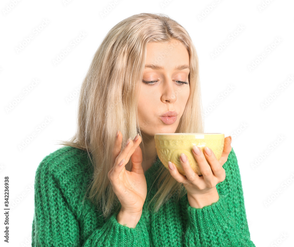 Beautiful young woman with tea on white background